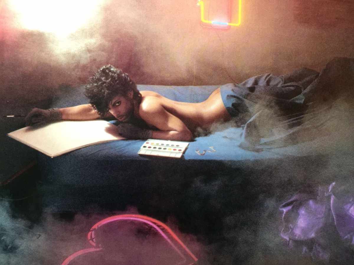 An image of the artist, Prince. He is reclining in bed preparing to paint some watercolors.